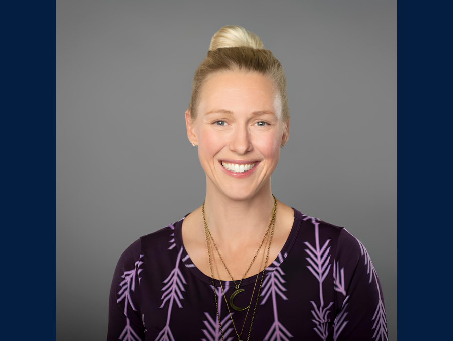 A headshot of a smiling woman.