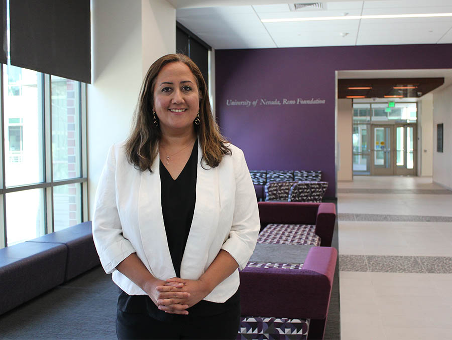 Woman in business attire stands in a hallway of the William Pennington Engineering Building.