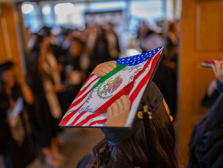 A decorated grad cap featuring the Mexican and American flags.