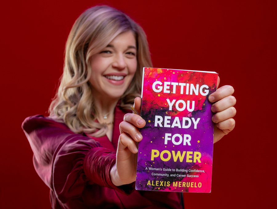 Alexis Meruelo holding her book, entitled "Getting You Ready for Power."
