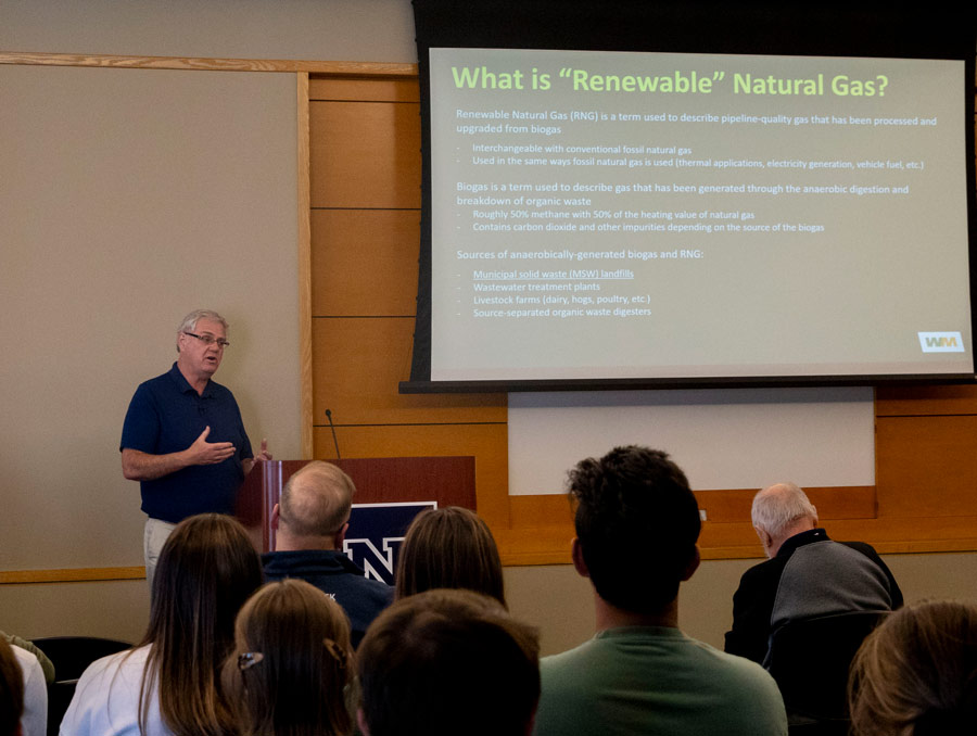 Christian Colline at the front of a room presenting to an audience.