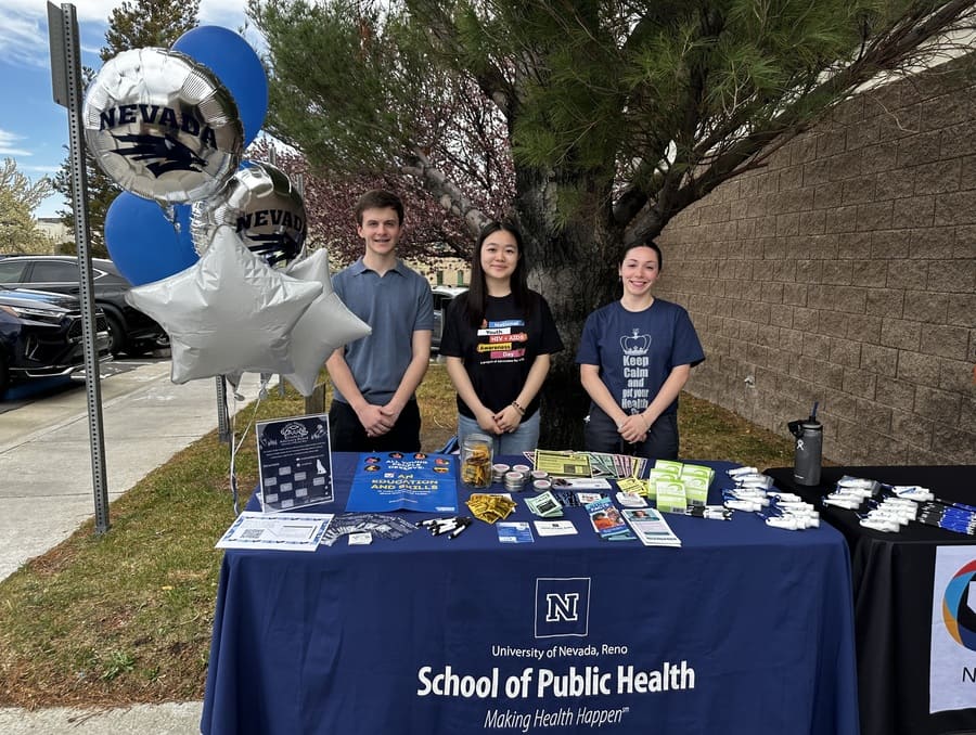 Group of students at a Condom Collective booth.
