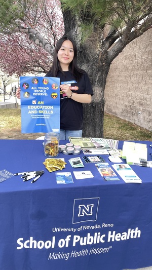 Claire Lin of the Condom Collective holds up a sign.