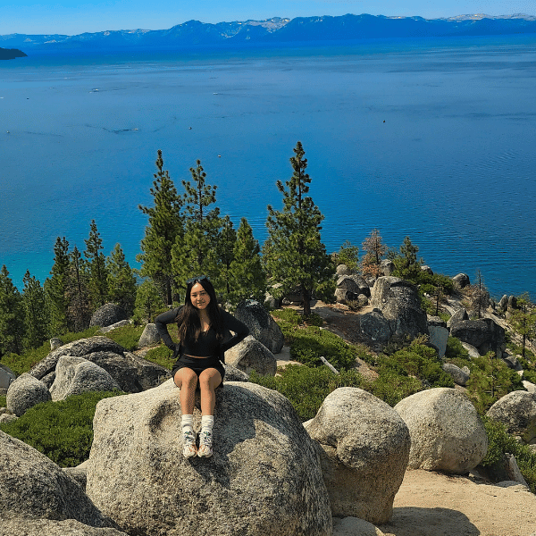 Ericka Estacio sitting on a rock above Tahoe. 