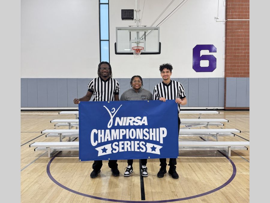 Tylar Tidwell, Abraham Pelayo and Jay Jordan holding NIRSA banner. 