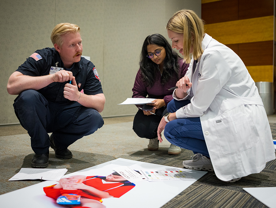 Students collaborate to triage a simulated patient.