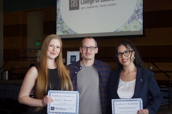 Gabby poses with another student and a professor during the awards ceremony.
