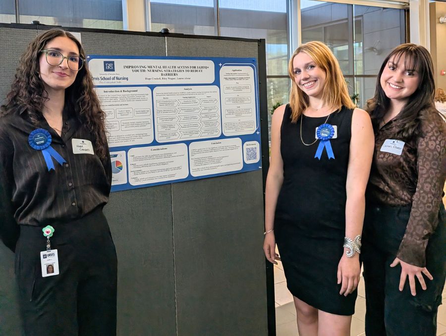 Hope Crockell, Riley Wagner and Lauren Alvear standing in front of their poster.