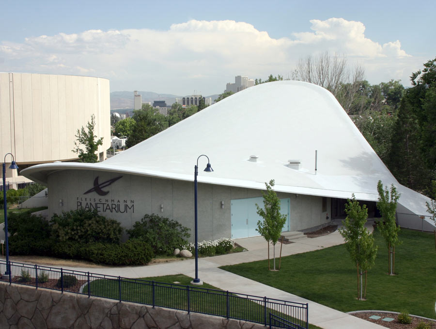 The Fleischmann Planetarium's hyperbolic parabola roof with Lawlor Stadium and the Reno skyline in the background.