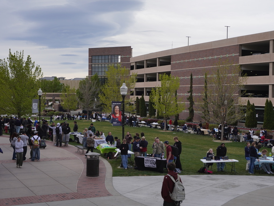 Students browse tables set up outdoors on campus during the Sales Expo, with rows of student-run booths on the Knowledge Center lawn.