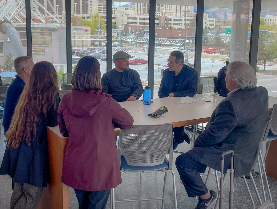Faculty and industry experts have a discussion in the John Tulloch Business Building.