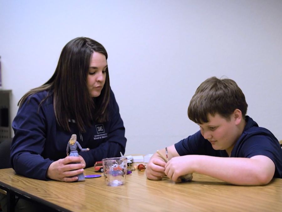 University Center for Autism and Neurodevelopmental clinician performing an assessment on a child. 