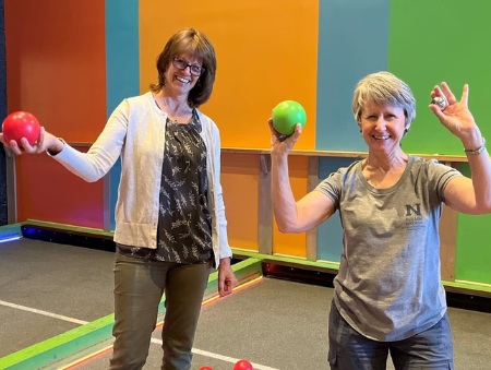 Marena Works and Karen Ross playing bocce at a School of Public Heatlh Alumni event
