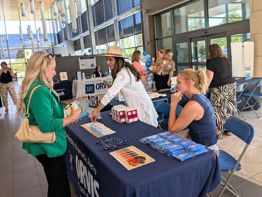 Attendees learning about resources at a tabling event