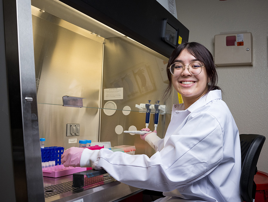 Samantha Sipusic in a lab coat working in the biobank.