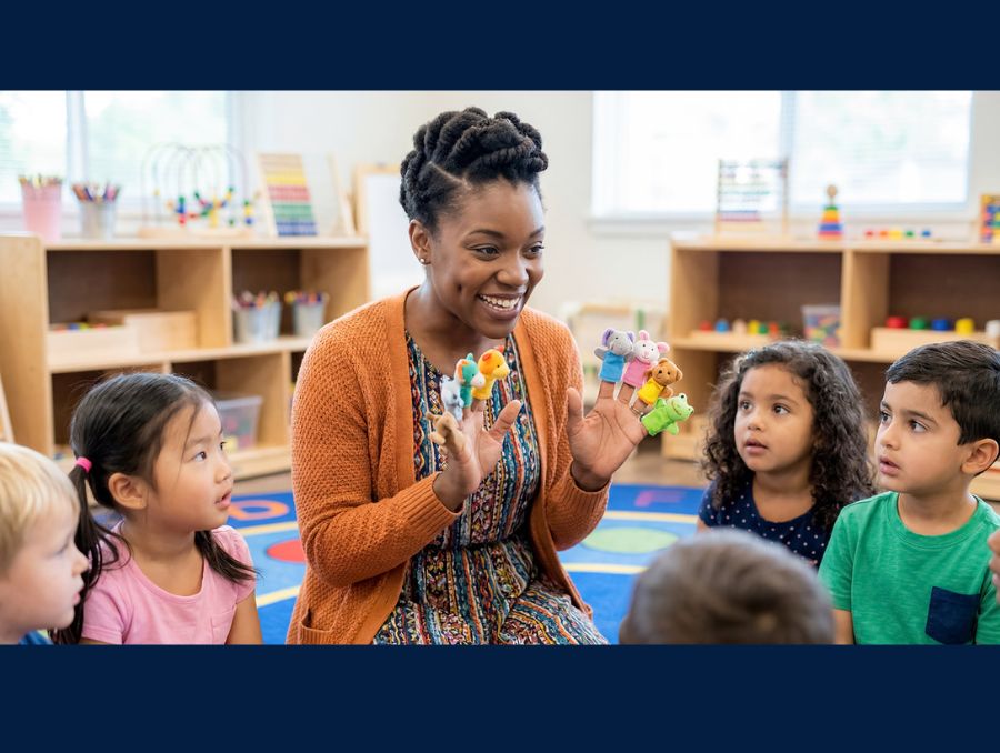 An early childhood educator interacting with children in a class. 