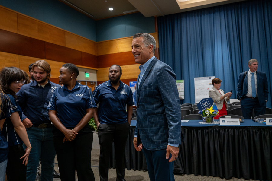 University President gathers with students.