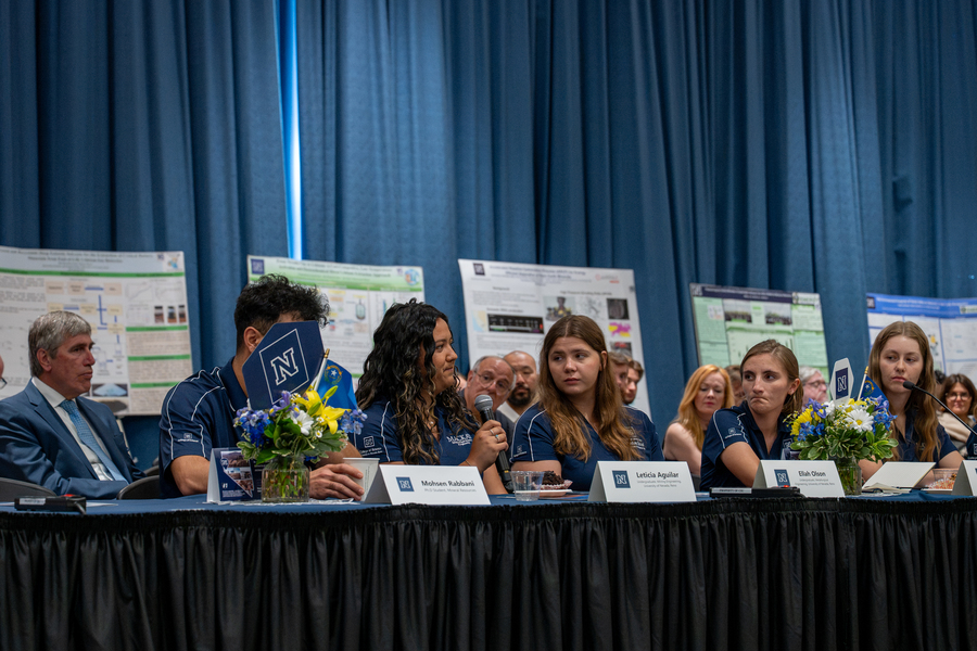 Students speaking on a panel. 