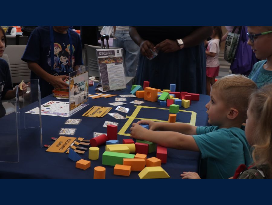 Children playing with toys set on a table. 