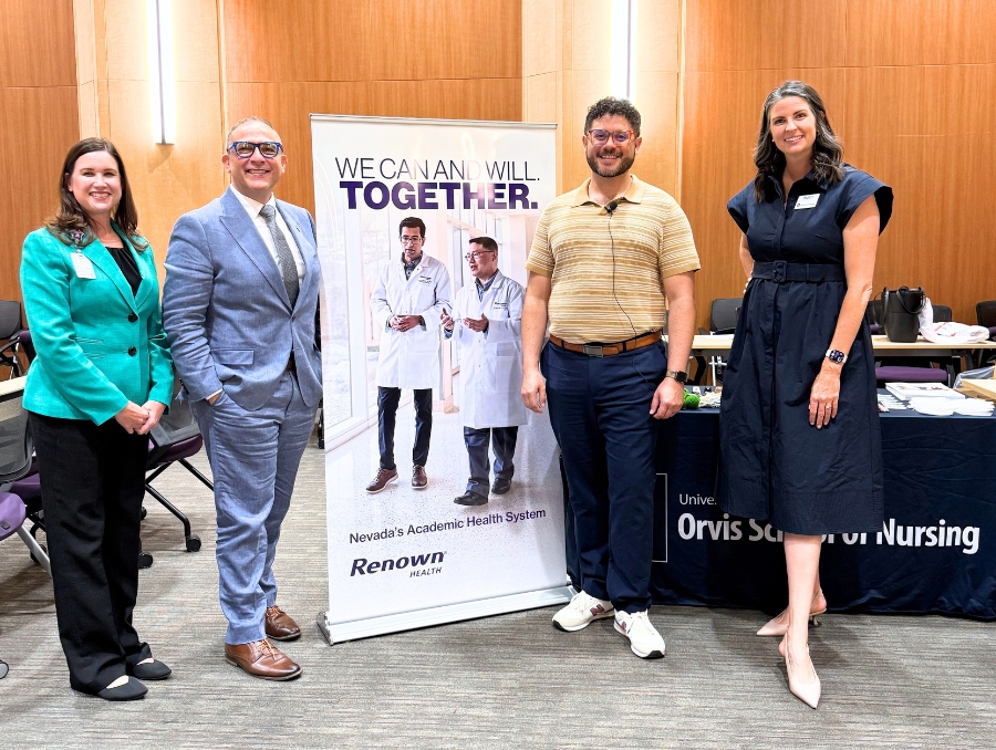 Melodie Osborn, Charlie Yingling, Adi Cabral and Molly Kokenge standing in front of a Renown banner at the Nursing Grand Rounds