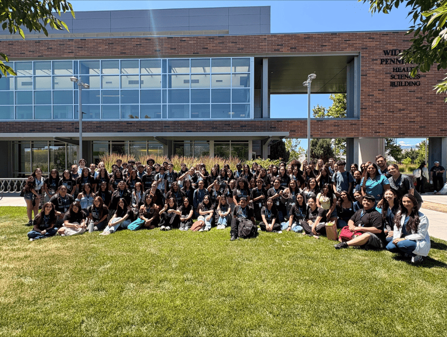 A group of students from the University of Nevada, Reno are posing on the grass.