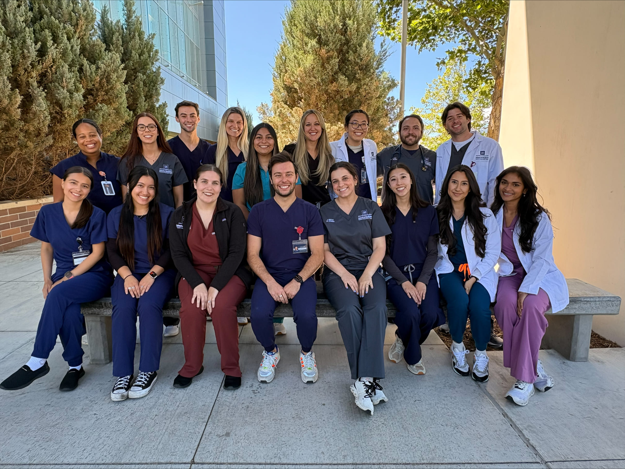 A group of University of Nevada, Reno students pose in their healthcare uniforms.