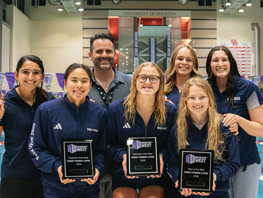 Nevada Swimming & Diving athletes holding award plaques posing with Nevada coaches.