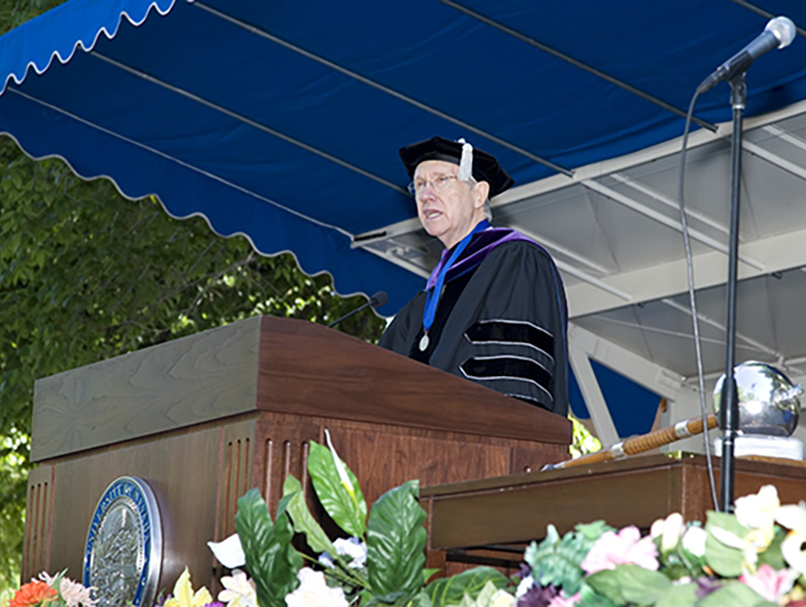 Senator Harry Reid, dressed in academic robes, addresses crowd at University of Nevada, Reno's 2007 Spring Commencement.