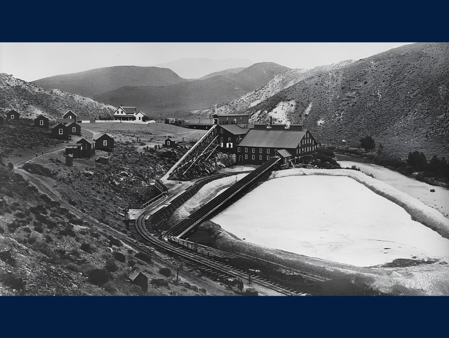 A black and white photograph of a historic mining town. 