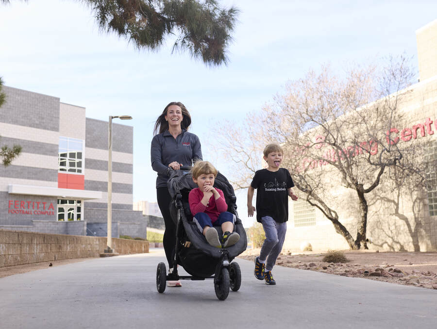Kara Radzak walking with two children.