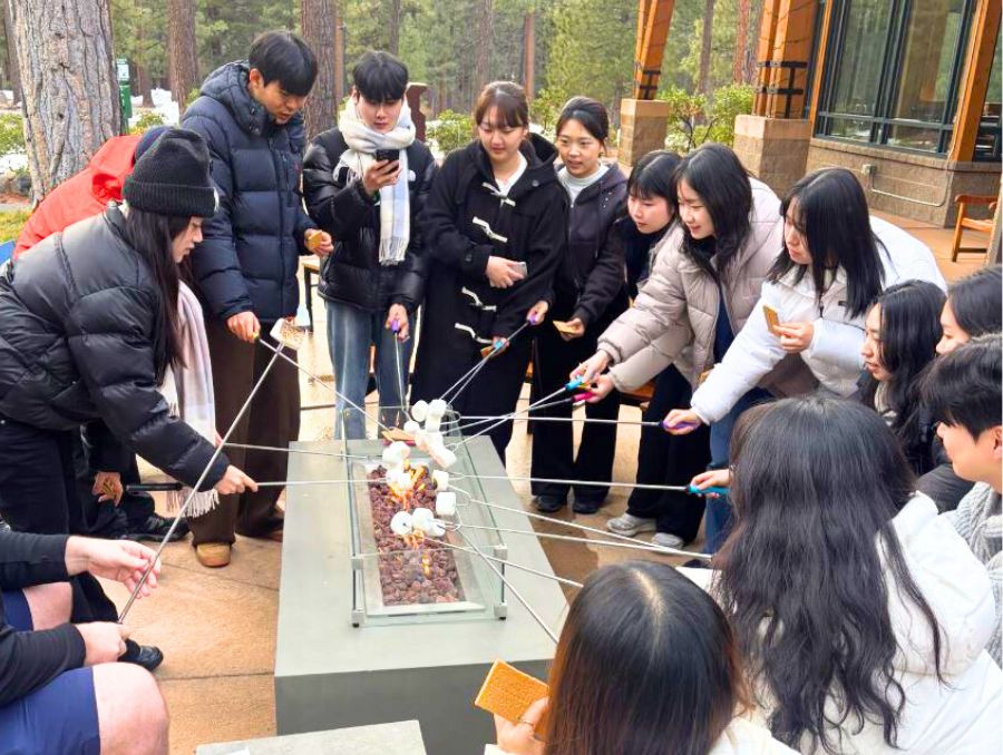 South Korean students roasting marshmallows at the Lake Tahoe campus.