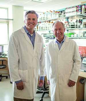 Kozel and AuCoin in a laboratory.