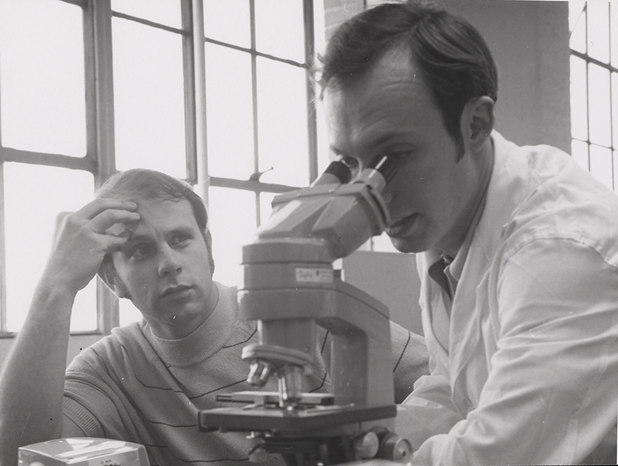 Kozel and medical student using a microscope in the 1970s.