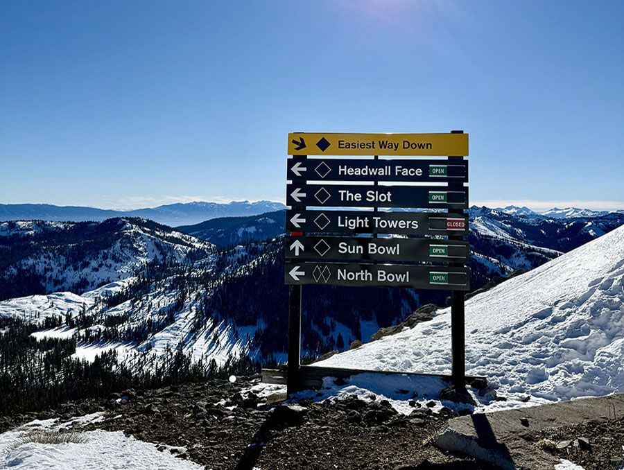 Sign showing ski/snowboard runs at Palisades Tahoe.