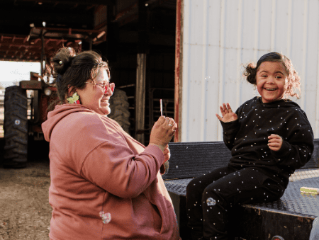 Mom and daughter smiling.