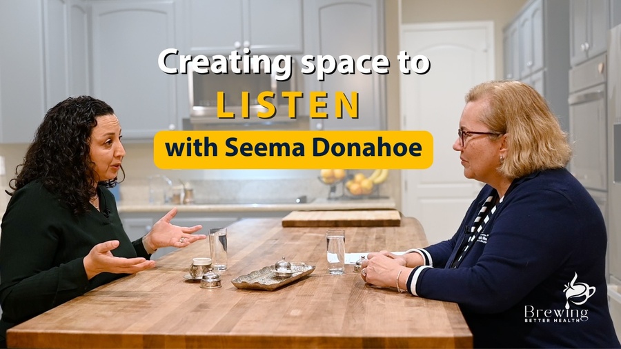 Seema Donahoe and Dean Muge Akpinar-Elci sitting at a table with coffee cups talking. The logo of the podcast is on the image with "Creating space to listen with Seema Donahoe" written and the Brewing Better Health logo.