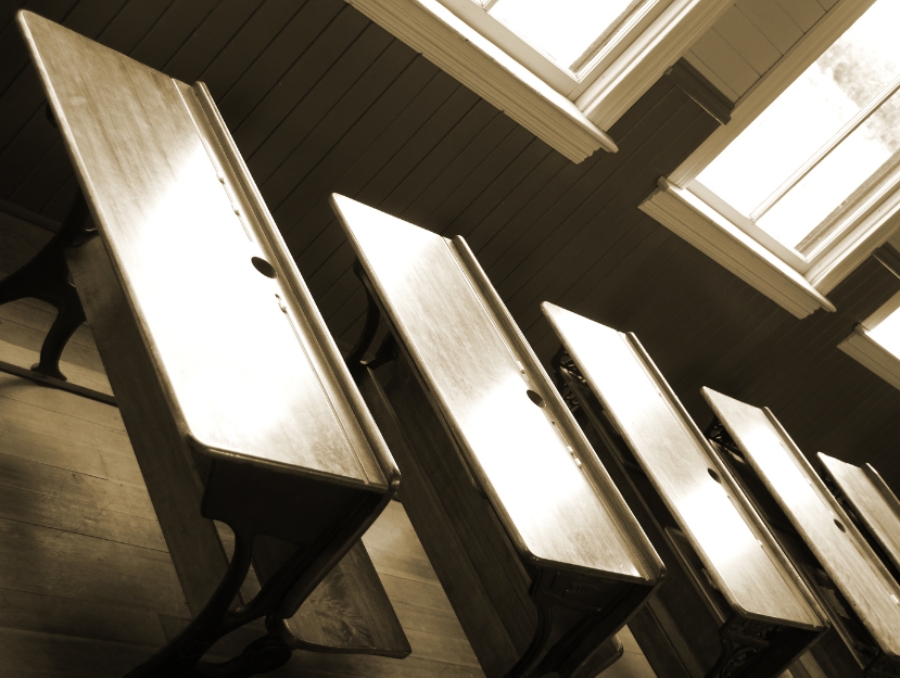 A row of empty desks in a classroom.