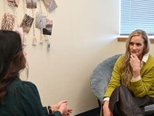 Dr. Ross listening to a faculty member at the Student Wellness Center.