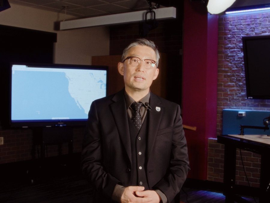 Dean Gi Yun speaking about the semester from the broadcast studio.