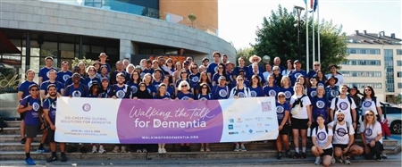 Members of the Walking the Talk for Dementia (WTD) 2026 Global Symposium holding a banner.