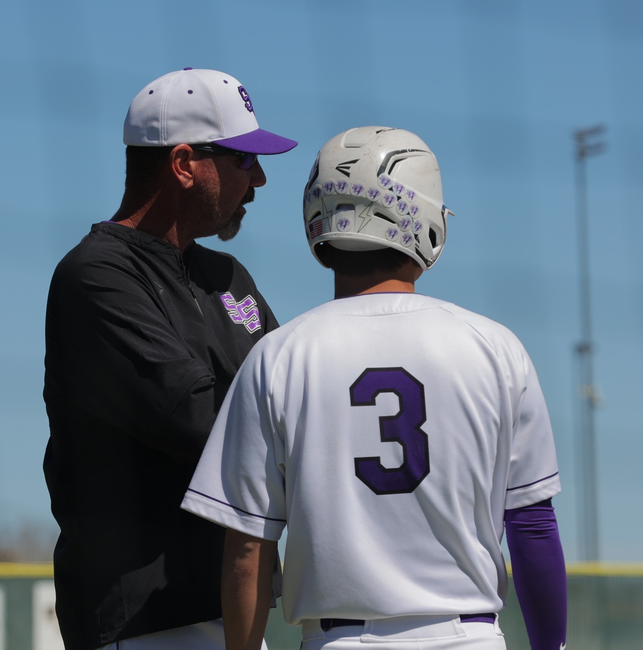 Bo Kindred and a baseball player dressed in baseball attire.
