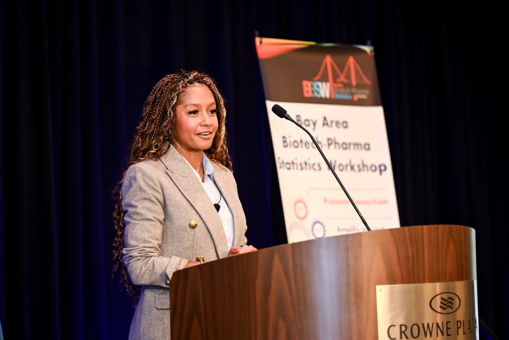 Dominique addressing a delegation in a corporate hall.