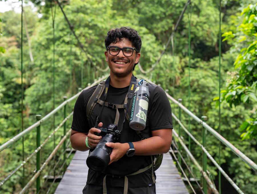 Josue Ponce poses with camera in jungle.