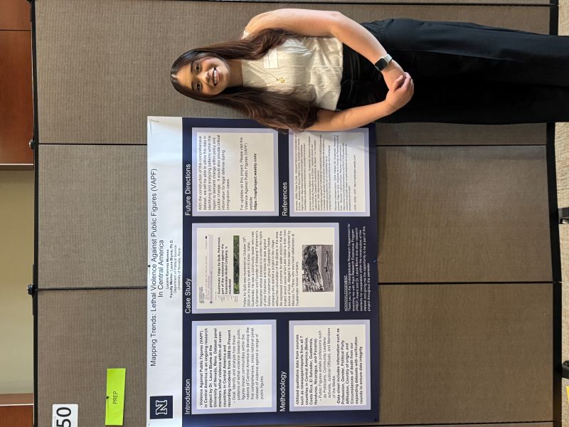 Ramirez Moreno smiling in front of a research poster.