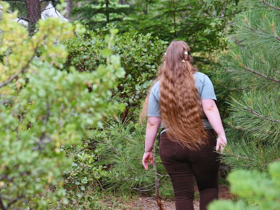 Sedona Zander walking through the woods.