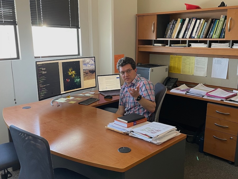 Sergey Varganov sitting at a desk, speaking.