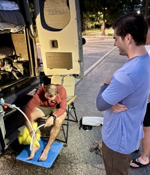 Medical students, Adrian Samberg and Ben Smith helping Nathan Hanneman rest at the Tahoe 200 race