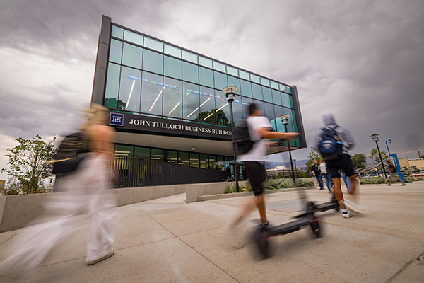 Students move past the John Tulloch Business Building.