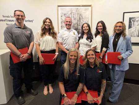 Team members from CASAT and REMSA with Reno Fire Chief David Cochran after receiving life-saving award certificates.
