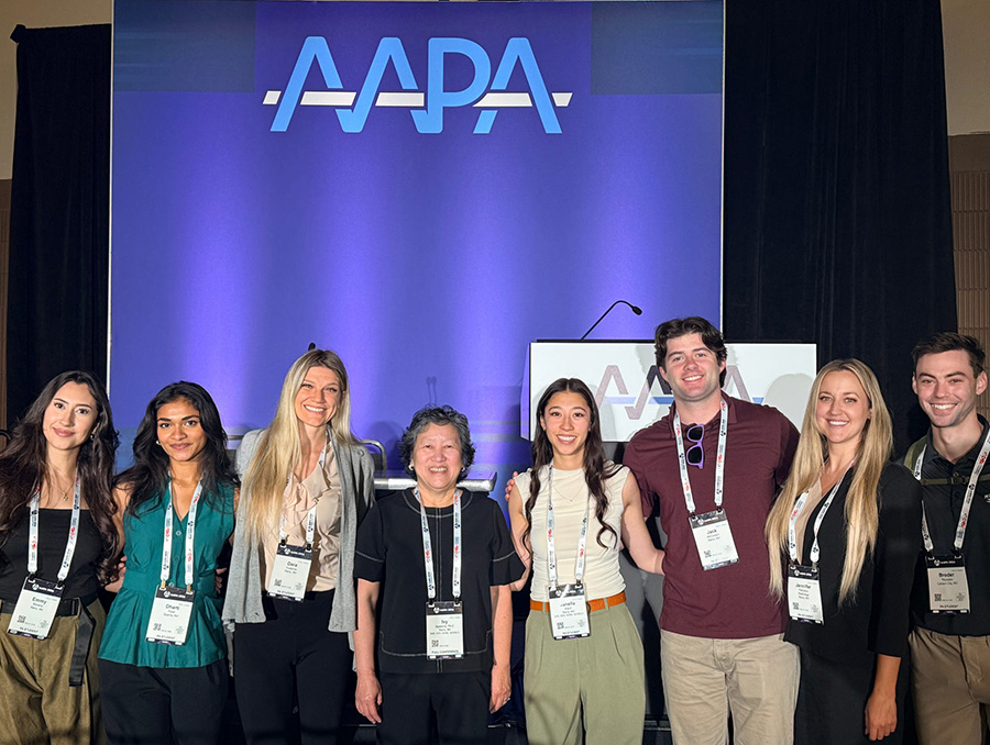 PA students in conference badges in front of a stage at the AAPA Conference.